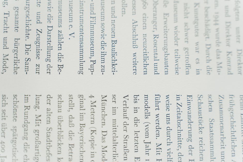 Detailed close-up of German text printed on white paper, focusing on typography.